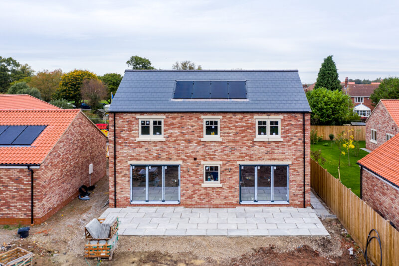 Skipwith, UK - October  20, 2021.  A new build home with built in photovoltaic solar panels in the roof generating clean and renewable energy for domestic use